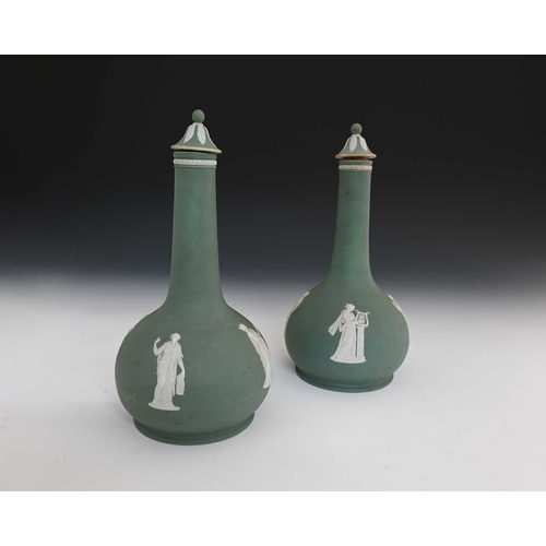 729 - Wedgwood for Humphrey Taylor & Co, London, a pair of buff green jasper dip liqueur bottles and stopp... 