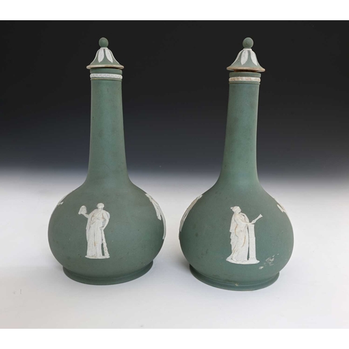 729 - Wedgwood for Humphrey Taylor & Co, London, a pair of buff green jasper dip liqueur bottles and stopp... 