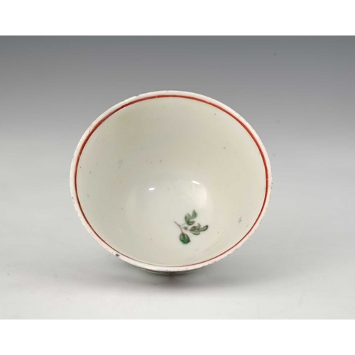 731 - A Bristol porcelain tea bowl, circa 1760s, painted with entwined ribbon and floral garlands, incised... 