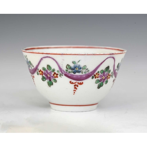 731 - A Bristol porcelain tea bowl, circa 1760s, painted with entwined ribbon and floral garlands, incised... 