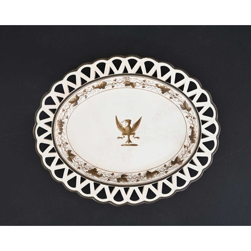 736 - A Swansea creamware reticulated plate, monochrome decorated with a central spreadeagle crest within ... 