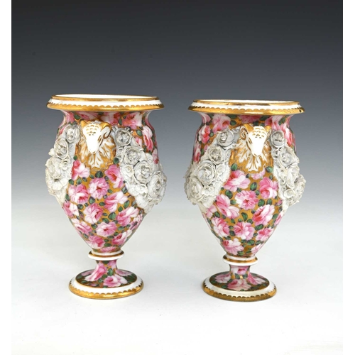 737 - A pair of early 19th Century Swansea porcelain urn shaped vases, circa 1815, with twin rams head han... 