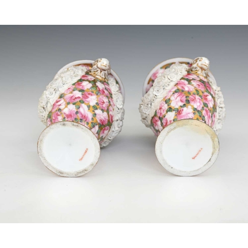 737 - A pair of early 19th Century Swansea porcelain urn shaped vases, circa 1815, with twin rams head han... 