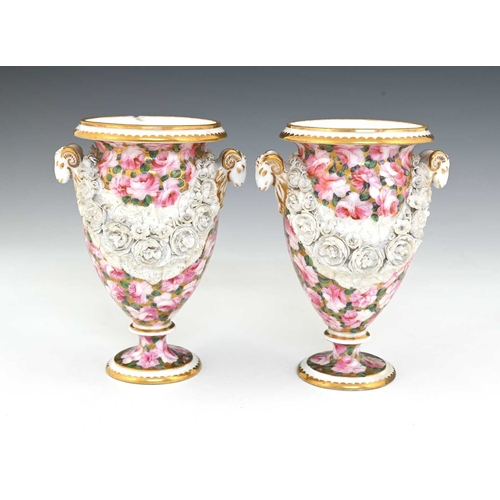 737 - A pair of early 19th Century Swansea porcelain urn shaped vases, circa 1815, with twin rams head han... 