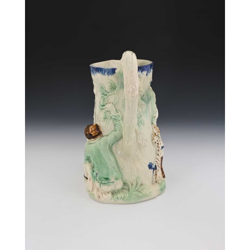 747 - A Staffordshire relief moulded jug, circa 1788, modelled in high relief as a tree stump with three p... 