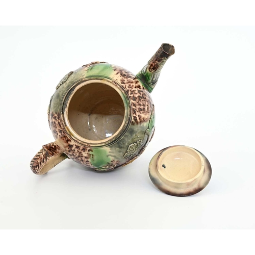 749 - A Whieldon sprigged teapot, circa 1740, spherical form with Rococo foliate handle, applied with reli... 