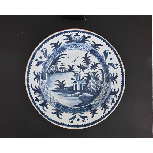 752 - A Lambeth Delft blue and white dish, circa 1780, painted with foliate decoration, 34.5cm diameter