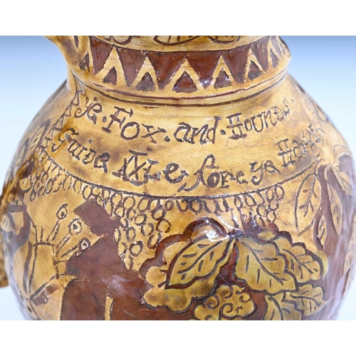 757 - An English slipware jug, sgraffito decorated in the West Country style with Ye Fox and Hounds, Phili... 