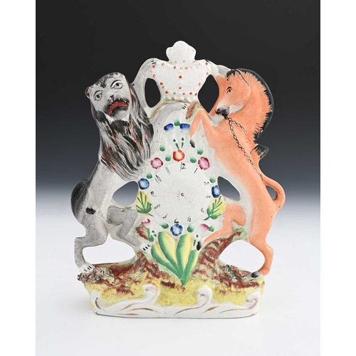 758 - A Staffordshire pottery figural clock, in the form of Royal Coat of Arms with lion and unicorn suppo... 