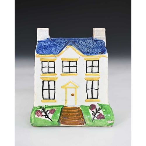 764 - A Mexborough Pottery money box, Yorkshire 19th century, modelled as a house