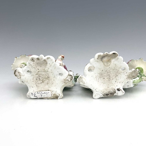 768 - A pair of Derby porcelain shepherd and shepherdess figural candlesticks, circa 1770, bocage backed, ... 