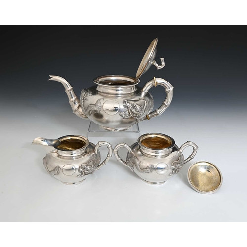 102 - China. An early twentieth-century Chinese export silver three-piece tea set, comprising teapot, two-... 