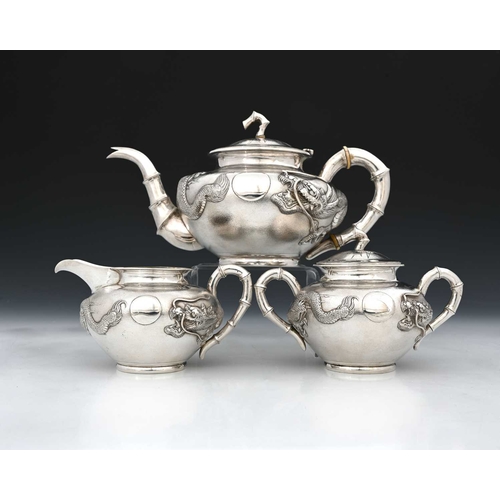 102 - China. An early twentieth-century Chinese export silver three-piece tea set, comprising teapot, two-... 