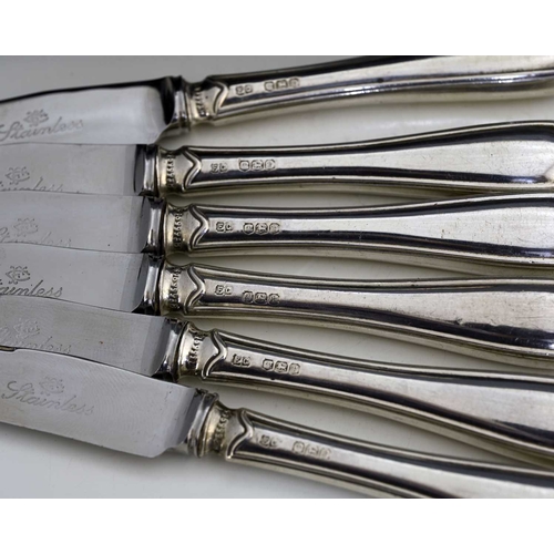 106 - A cased set of six George V tea knives, each with hallmarked silver handle and steel blade, the hand... 