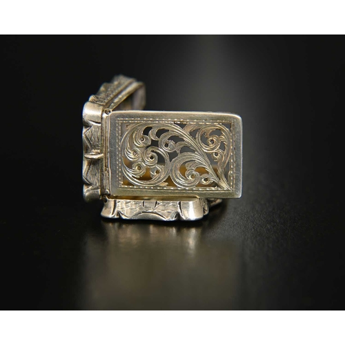 11 - A Victorian silver vinaigrette, of shaped rectangular form, the exterior decorated with engine turni... 