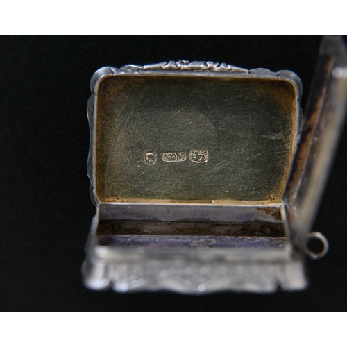 11 - A Victorian silver vinaigrette, of shaped rectangular form, the exterior decorated with engine turni... 