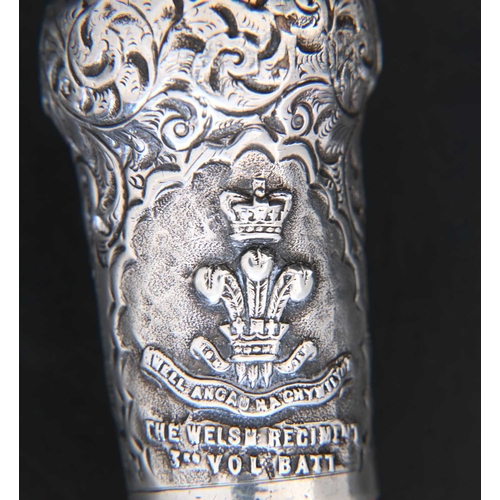 115 - Welsh Regiment Interest.

An Edwardian silver-mounted walking cane, the hallmarked silver pommel dec... 