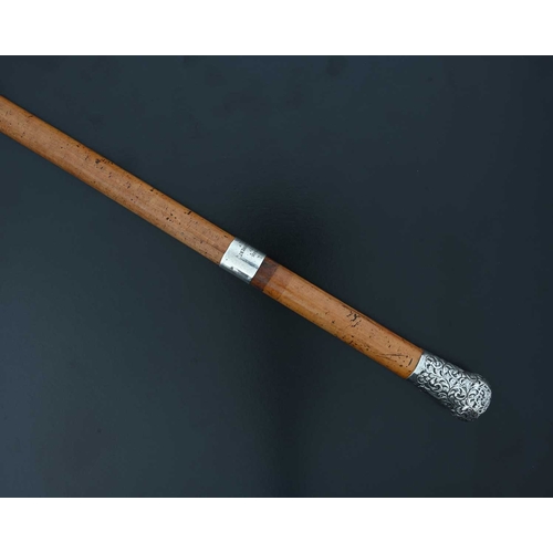 115 - Welsh Regiment Interest.

An Edwardian silver-mounted walking cane, the hallmarked silver pommel dec... 