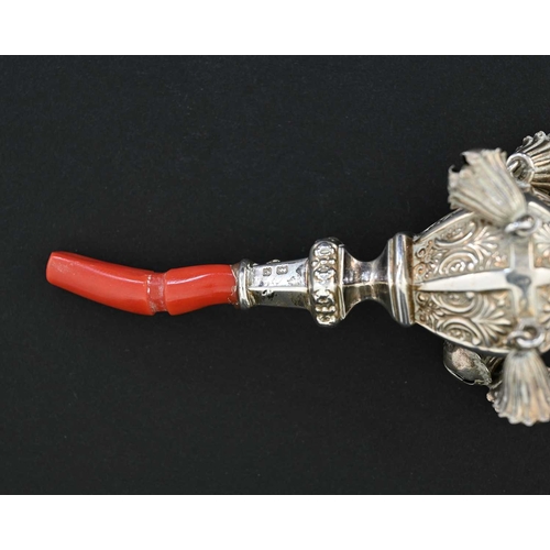 30 - An Edwardian silver child's rattle, the faceted decorated body ensuite with six attached bells, with... 