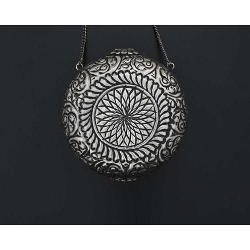 36 - A silver-coloured metal evening purse or bag, of circular form, the exterior decorated with foliate ... 