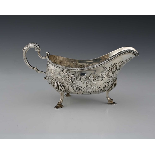 49 - A late Victorian silver sauce boat, modelled in the eighteenth-century Rococo style, decorated with ... 