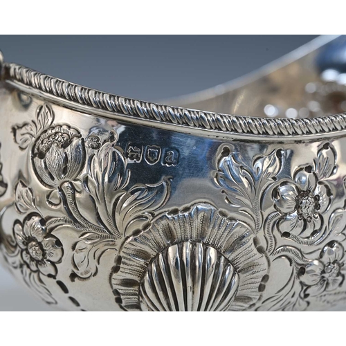 49 - A late Victorian silver sauce boat, modelled in the eighteenth-century Rococo style, decorated with ... 