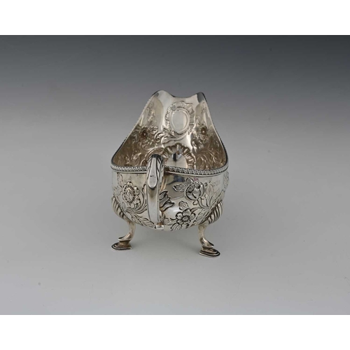 49 - A late Victorian silver sauce boat, modelled in the eighteenth-century Rococo style, decorated with ... 