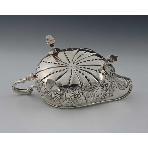 49 - A late Victorian silver sauce boat, modelled in the eighteenth-century Rococo style, decorated with ... 