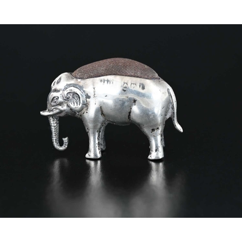 52 - An Edwardian silver novelty pin cushion, modelled in the form of a standing elephant, ensuite with c... 