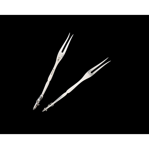 65 - Georg Jensen. A matched pair of silver Georg Jensen blossom forks, also struck with British import m... 