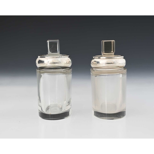 66 - A matched set of early twentieth-century silver-mounted glass perfume bottles or toilet bottles, eac... 