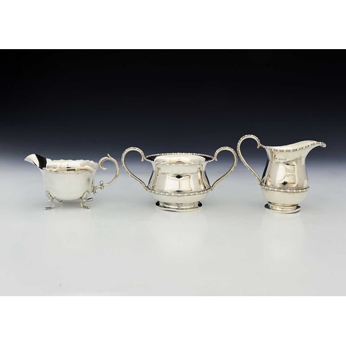 73 - A George V silver strawberry set, comprising cream jug and sugar bowl, Fred H Adams & Co, Birmingham... 