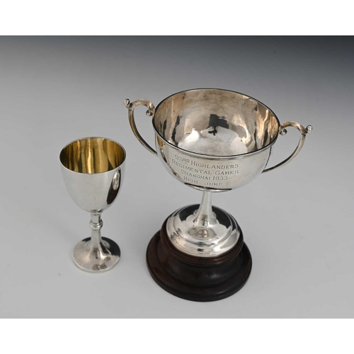 91 - China. Two twentieth-century Chinese silver trophy cups, including a two-handled cup atop a turned w... 