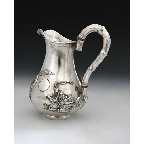 93 - China. An early twentieth-century Chinese export silver ewer, of bellied form, decorated in relief w... 