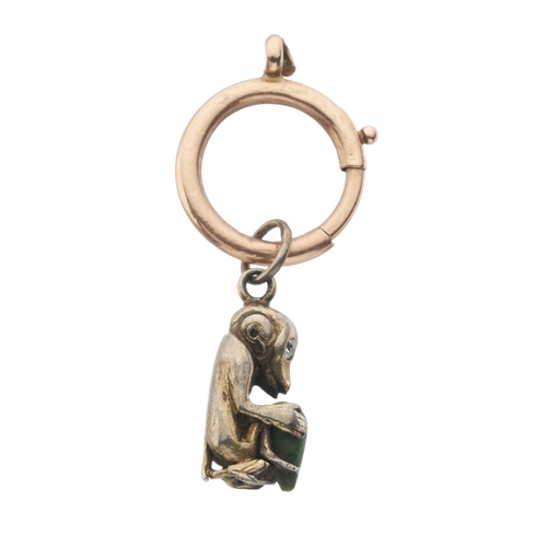 11 - An early 20th century Chinese charm, designed as a monkey holding a jade nut, with old-cut diamond e... 