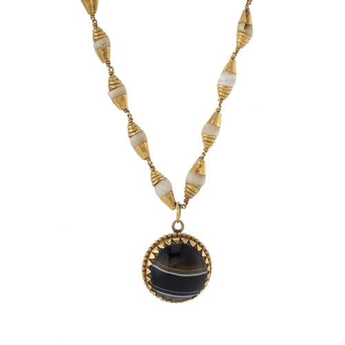 144 - A late 19th century gold agate cabochon pendant, suspended from an unusual gold mounted shell-link c... 