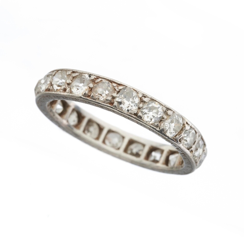 150 - An early 20th century platinum old-cut diamond full eternity ring, with engraved sides, estimated to... 