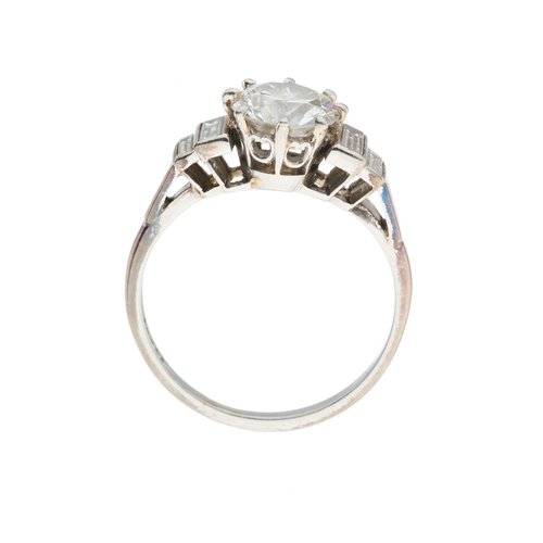 161 - An Art Deco platinum circular-cut diamond single-stone ring, with graduated rectangular-shape diamon... 