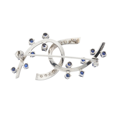 176 - An 18ct gold sapphire and single-cut diamond entwined scroll brooch, estimated total diamond weight ... 