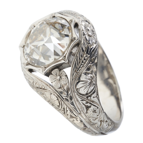 194 - An old-cut diamond single-stone band ring, with floral engraved surround and shoulders, diamond esti... 