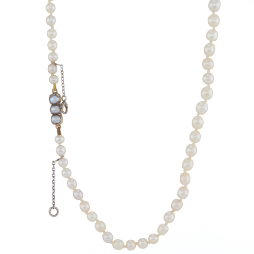 23 - An early 20th century natural pearl single-strand necklace, with gold pearl accent push-piece clasp,... 