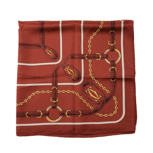 309 - Cartier, a Must De Cartier silk scarf, decorated with gold-tone chains and belt straps linked togeth... 