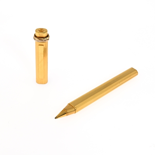 310a - Cartier, a Must de Cartier Vendome gold-plated ballpoint pen, featuring a ribbed pinstripe design wi... 