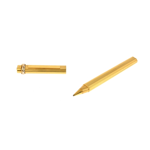 310a - Cartier, a Must de Cartier Vendome gold-plated ballpoint pen, featuring a ribbed pinstripe design wi... 