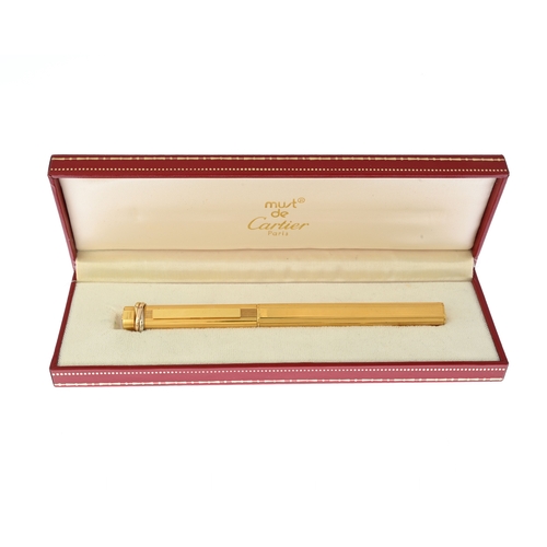 310a - Cartier, a Must de Cartier Vendome gold-plated ballpoint pen, featuring a ribbed pinstripe design wi... 