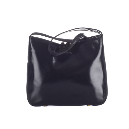 313 - Celine, a vintage black leather handbag, designed with a glossy black leather exterior and black nyl... 