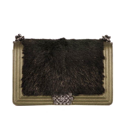 319 - Chanel, a New Medium Boy bag, featuring a black faux fur front panel and gold leather trim, with a r... 