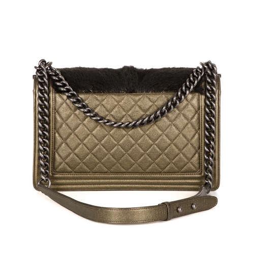 319 - Chanel, a New Medium Boy bag, featuring a black faux fur front panel and gold leather trim, with a r... 