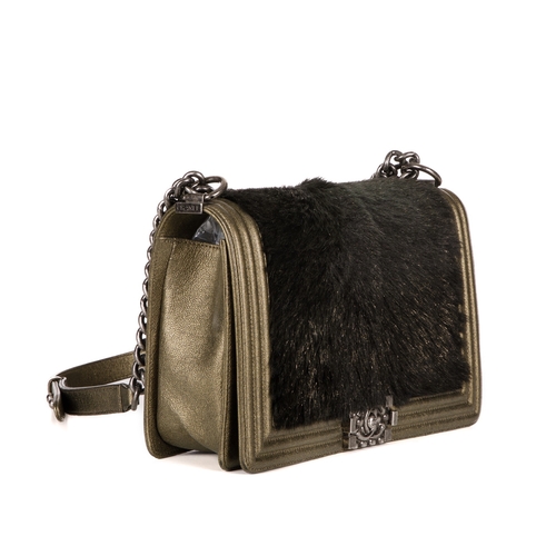 319 - Chanel, a New Medium Boy bag, featuring a black faux fur front panel and gold leather trim, with a r... 