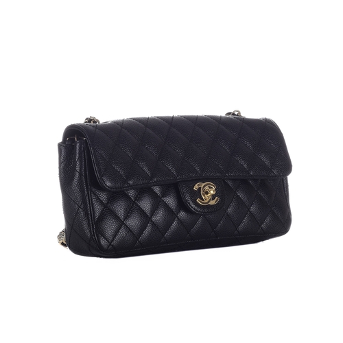 323 - Chanel, a black caviar East West single flap handbag, featuring the maker's iconic black quilted cav... 